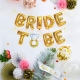 Set baloane din folie metalizata, model Bride to Be cu inel de logodna, litere de 40 cm, baloane party, ambalaj individual, pai inclus, auriu